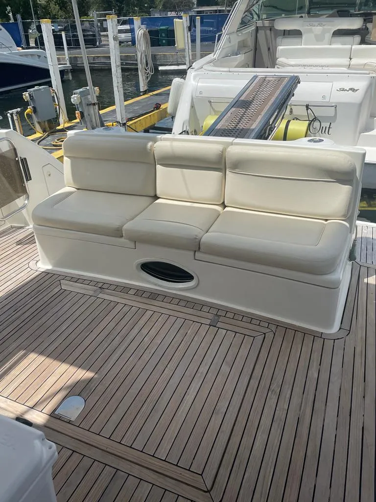 Slide: The Image of 2001 Azimut 58 yacht with beige cushioned seating on teak deck. - 5