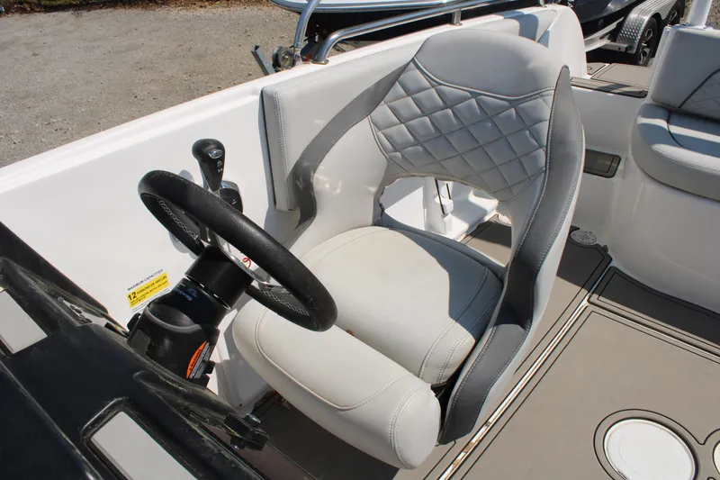 Slide: The Image of Captain's chair and steering wheel of a 2022 Sea Pro Citation 2400 boat. - 12
