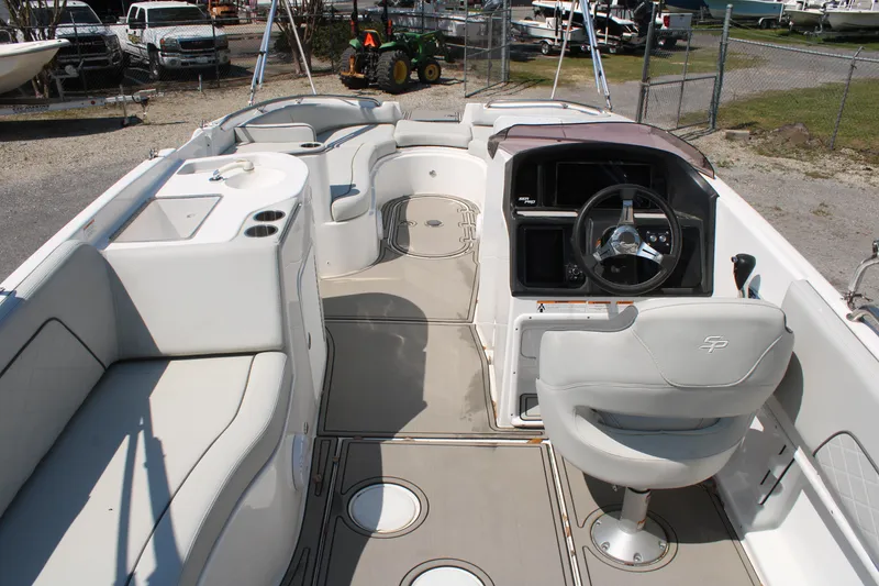 Slide: The Image of 2022 Sea Pro Citation 2400 boat interior with helm, seating, and storage compartments. - 14