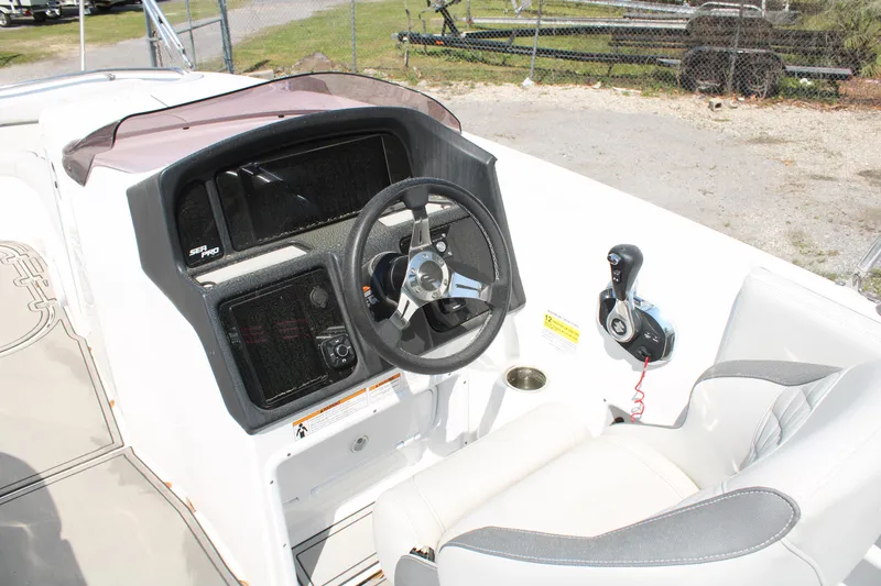 Slide: The Image of 2022 Sea Pro Citation 2400 boat cockpit with steering wheel and control panel. - 9