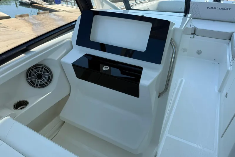 Slide: The Image of 2025 World Cat 260 DC-X boat interior with sleek dashboard and speaker system. - 12