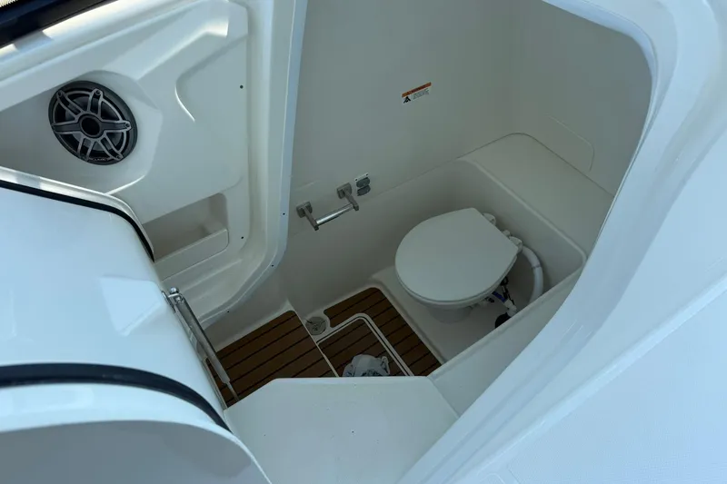 Slide: The Image of 2025 World Cat 260 DC-X boat interior with toilet and speaker system. - 13