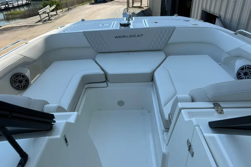 Slide: The Image of 2025 World Cat 260 DC-X boat interior with white seating and speakers. - 14
