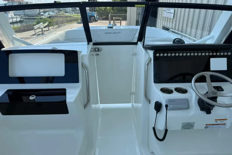 Slide: The Image of Interior view of 2025 World Cat 260 DC-X boat cockpit with steering wheel and controls. - 15