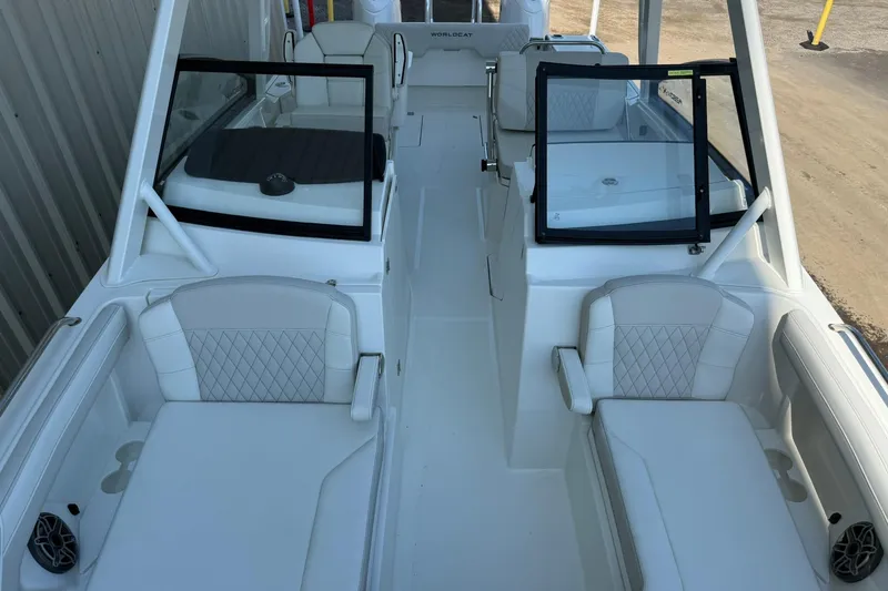 Slide: The Image of 2025 World Cat 260 DC-X boat interior with white seating and dual consoles. - 17
