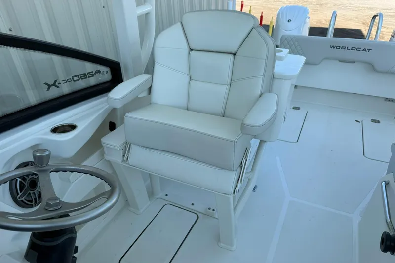Slide: The Image of 2025 World Cat 260 DC-X boat interior with white captain's chair and steering wheel. - 19