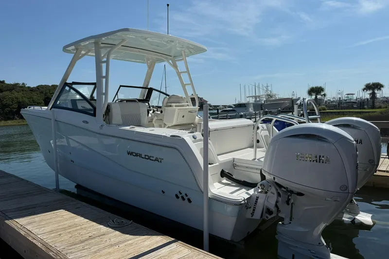 Slide: The Image of 2025 World Cat 260 DC-X boat docked with dual Yamaha engines. - 2