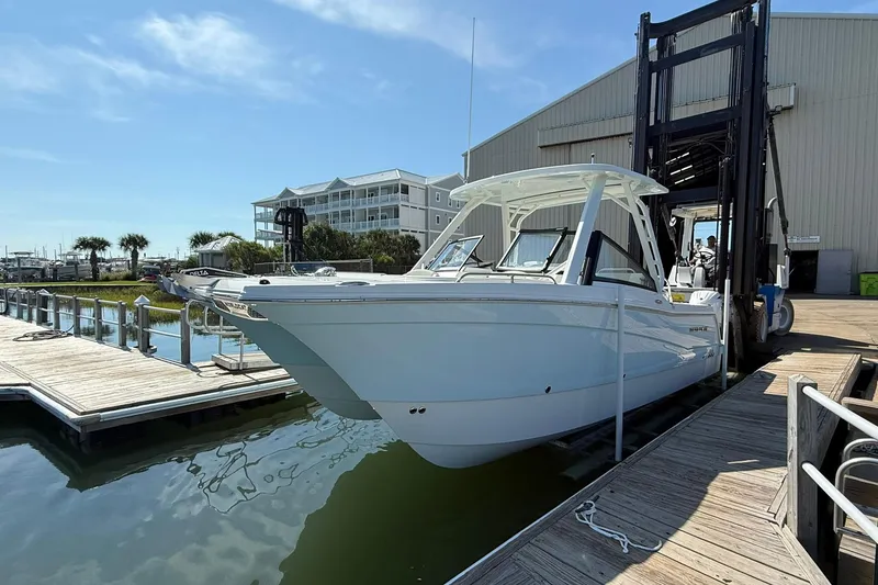 Slide: The Image of 2025 World Cat 260 DC-X boat docked at marina under clear blue sky. - 3