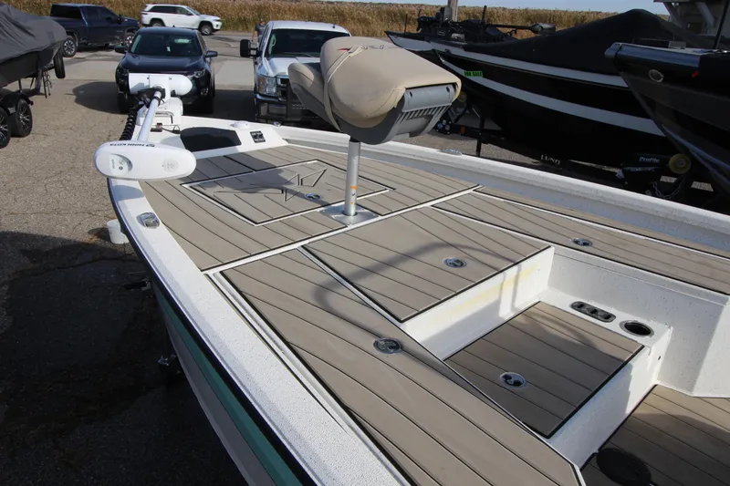 Slide: The Image of 2023 Vexus AVX 2180 CC boat with spacious deck and seating in a marina. - 10