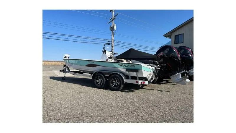 Slide: The Image of 2023 Vexus AVX 2180 CC boat on a trailer, parked outdoors. - 2