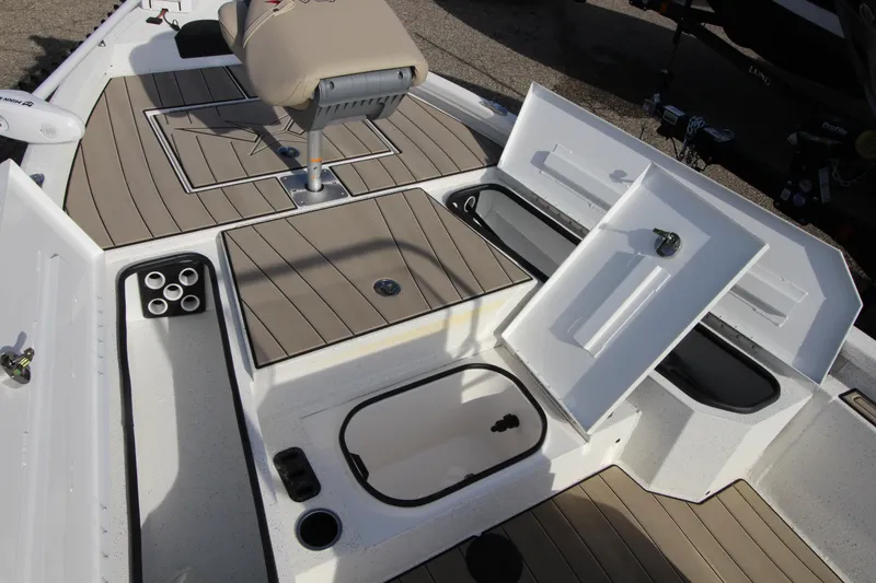 Slide: The Image of 2023 Vexus AVX 2180 CC boat interior with open storage compartments and seating. - 20