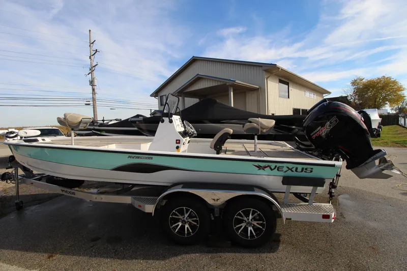 Slide: The Image of 2023 Vexus AVX 2180 CC boat on trailer, parked outdoors. - 8