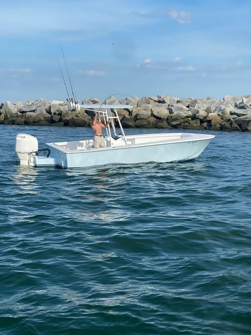 The Image of 2019 Albemarle CAPPS Custom Center Console boat on the water near rocky shore. - 1