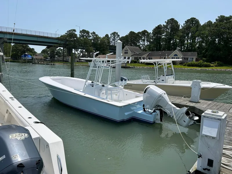 Slide: The Image of 2019 Albemarle CAPPS Custom Center Console boat docked in a serene marina. - 4