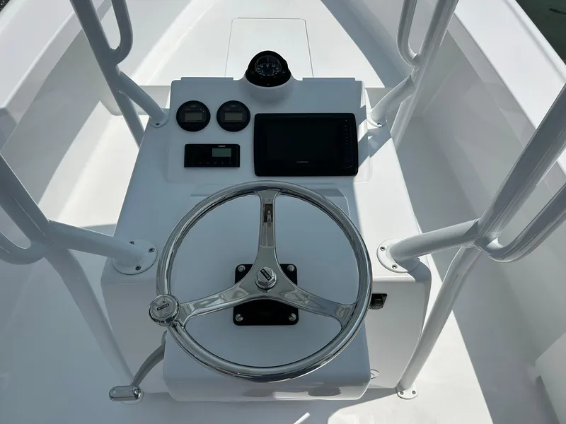 Slide: The Image of 2019 Albemarle CAPPS Custom Center Console boat helm with steering wheel and navigation instruments. - 6