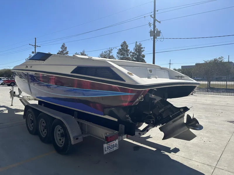 Slide: The Image of 1994 Wellcraft 2900 Sportboat on trailer, rear view, outdoors. - 2