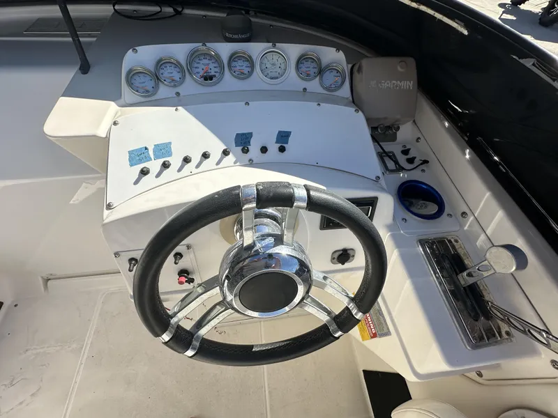 Slide: The Image of 1994 Wellcraft 2900 Sportboat dashboard with steering wheel and control panel. - 4
