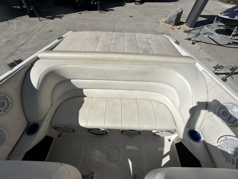 Slide: The Image of 1994 Wellcraft 2900 Sportboat interior with white cushioned seating and built-in speakers. - 5
