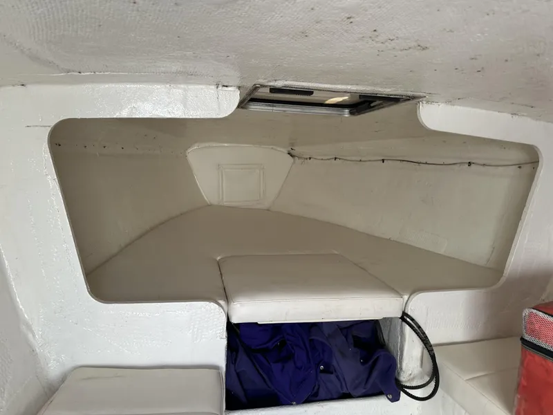 Slide: The Image of Interior cabin of a 1994 Wellcraft 2900 Sportboat with white cushioned seating. - 6