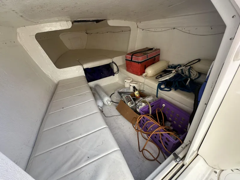 Slide: The Image of Interior cabin of a 1994 Wellcraft 2900 Sportboat with storage items and seating. - 7