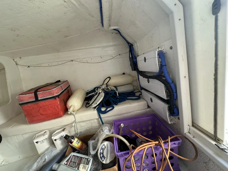 Slide: The Image of Interior storage area of a 1994 Wellcraft 2900 Sportboat with various boating equipment. - 8