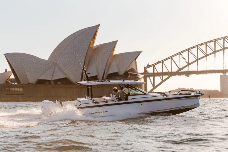 Slide: The Image of 2024 Axopar 37 Sun Top cruising near Sydney Opera House and Harbour Bridge. - 8