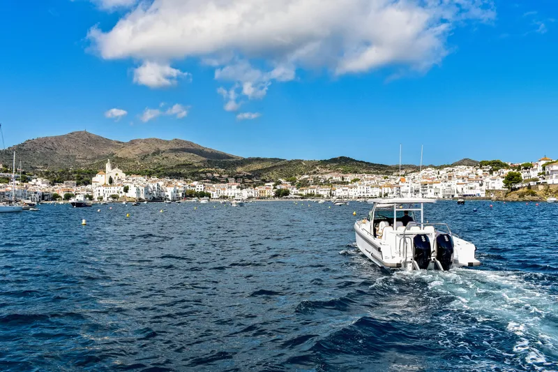 Slide: The Image of 2024 Axopar 37 Sun Top cruising in scenic coastal waters. - 9