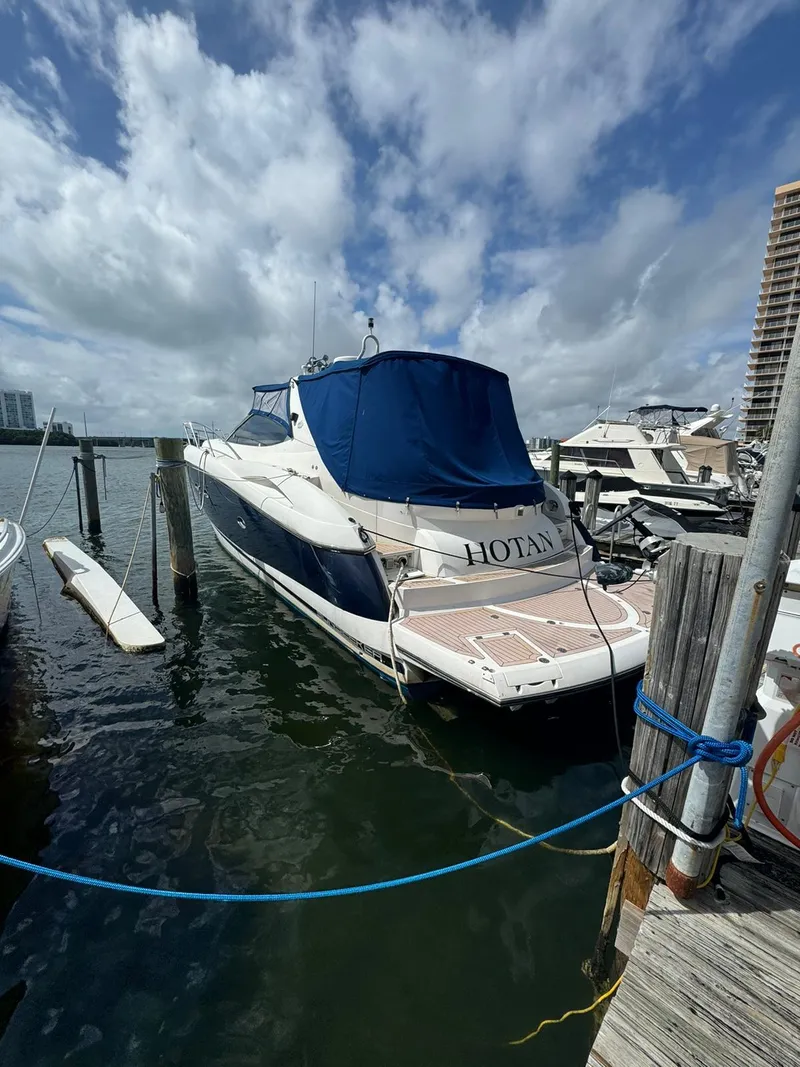 Slide: The Image of 2003 Sunseeker Portofino 46 yacht docked at marina under cloudy sky. - 1