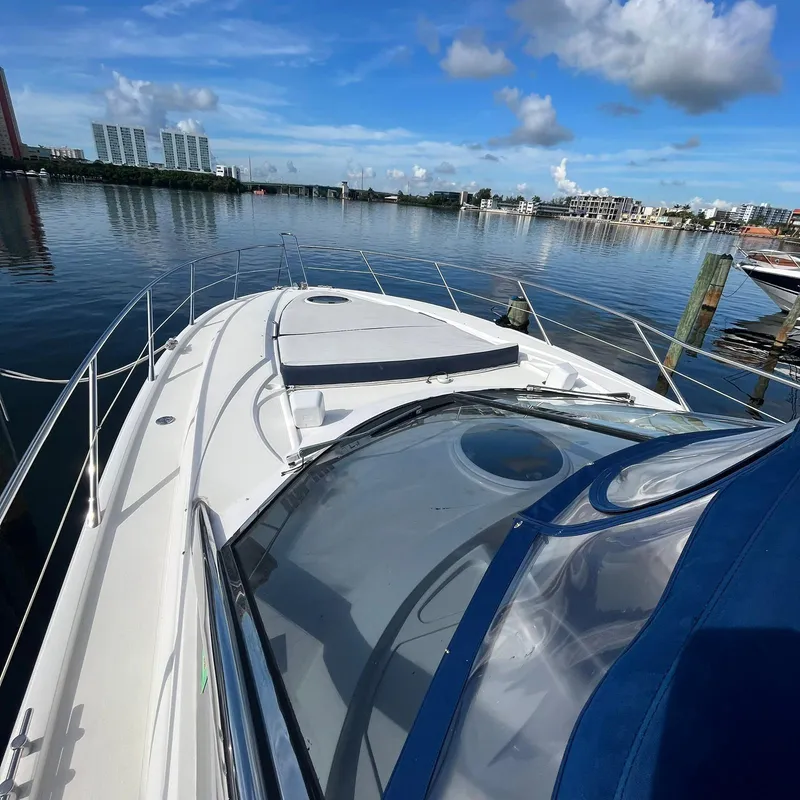 Slide: The Image of 2003 Sunseeker Portofino 46 yacht docked in a serene marina. - 11