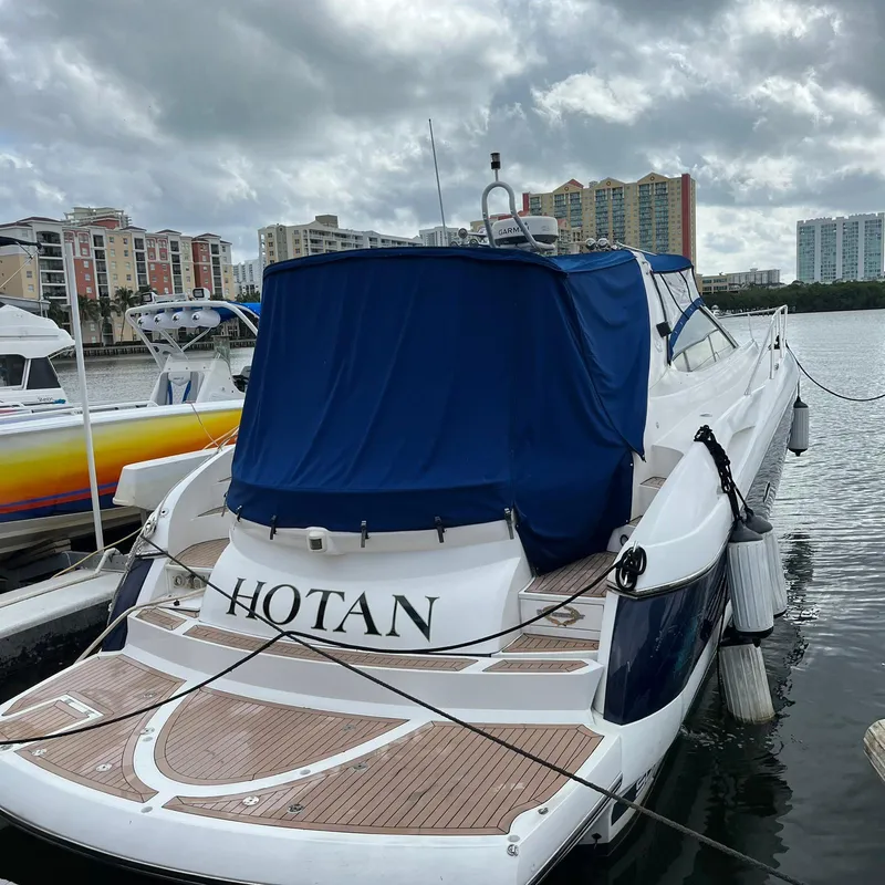 Slide: The Image of 2003 Sunseeker Portofino 46 yacht docked at marina with blue cover. - 15