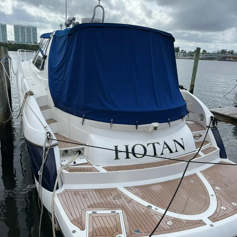 Slide: The Image of 2003 Sunseeker Portofino 46 yacht docked, rear view with blue cover. - 16