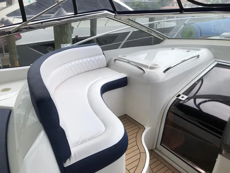 Slide: The Image of 2003 Sunseeker Portofino 46 yacht interior with white and navy seating. - 26