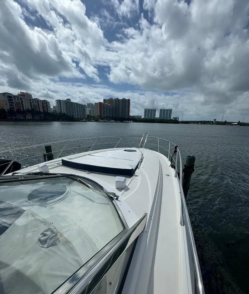 Slide: The Image of 2003 Sunseeker Portofino 46 yacht docked with city skyline in the background. - 3