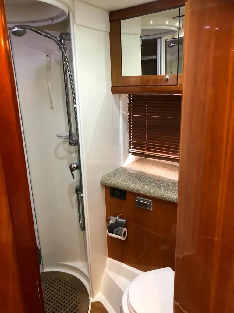 Slide: The Image of 2003 Sunseeker Portofino 46 yacht bathroom with shower, sink, and wooden cabinetry. - 34