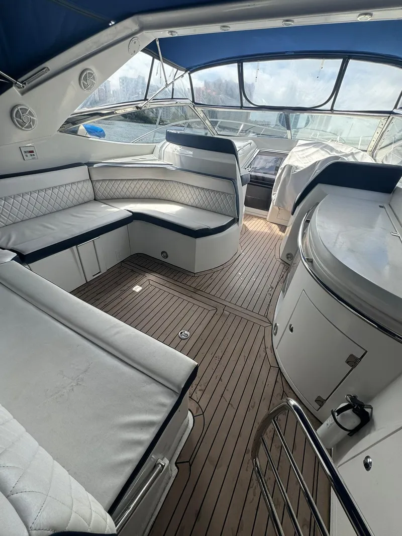 Slide: The Image of Interior of 2003 Sunseeker Portofino 46 yacht with white seating and wooden flooring. - 4
