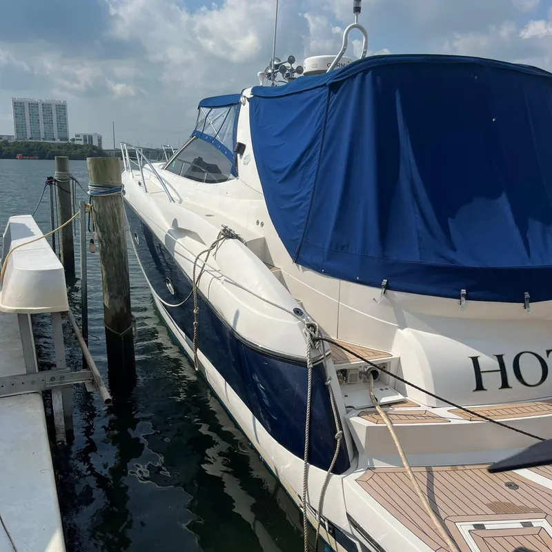 Slide: The Image of 2003 Sunseeker Portofino 46 yacht docked at marina with blue cover. - 6
