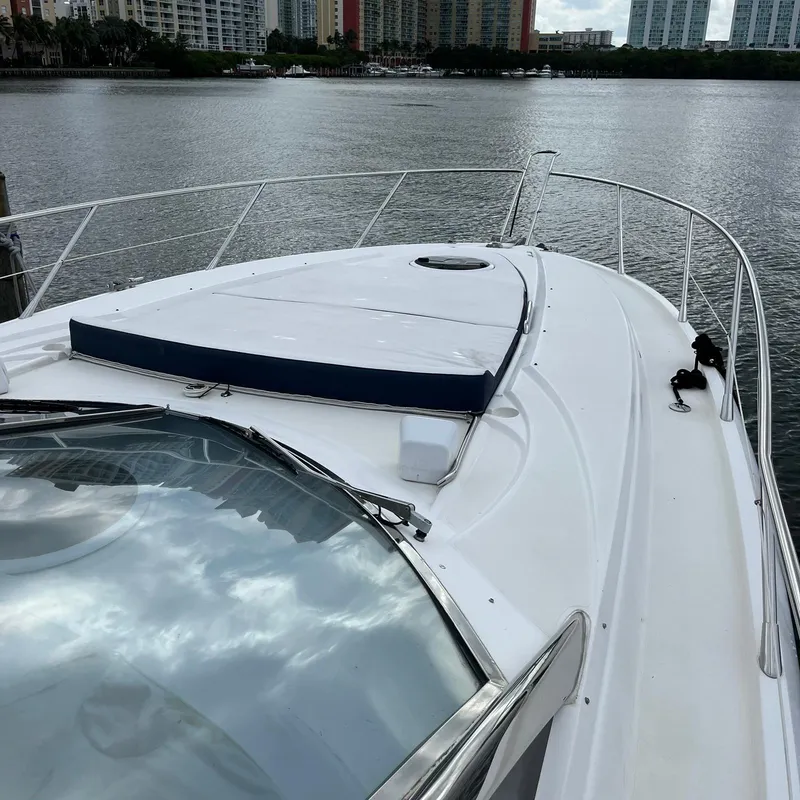 Slide: The Image of 2003 Sunseeker Portofino 46 yacht bow view with cityscape background. - 9