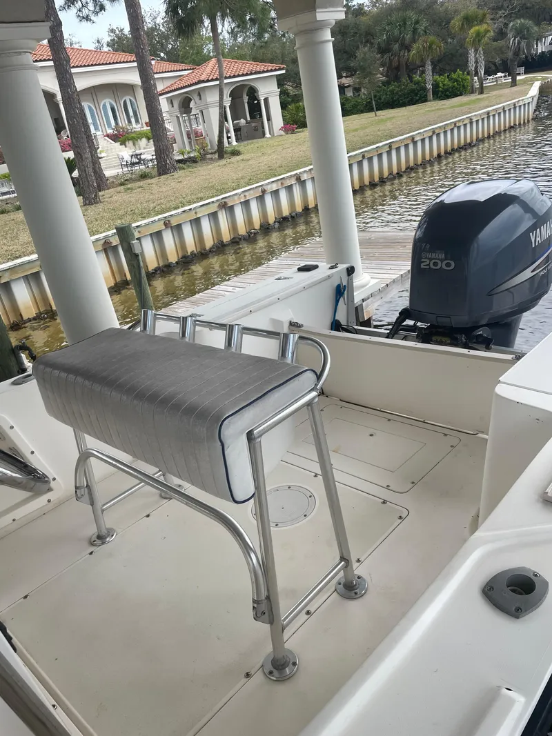 Slide: The Image of 1992 Mako 221 CC boat with Yamaha 200 outboard motor docked near waterfront property. - 15