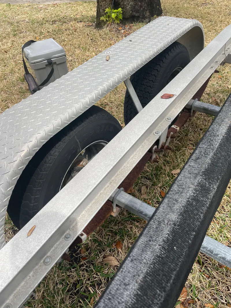 Slide: The Image of Close-up of a 1992 Mako 221 CC boat trailer with dual wheels. - 23