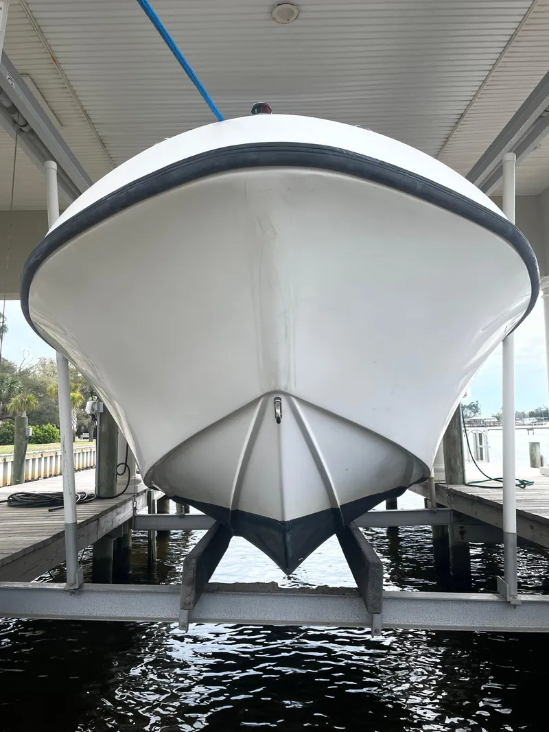 Slide: The Image of 1992 Mako 221 CC boat on a lift, front view. - 3