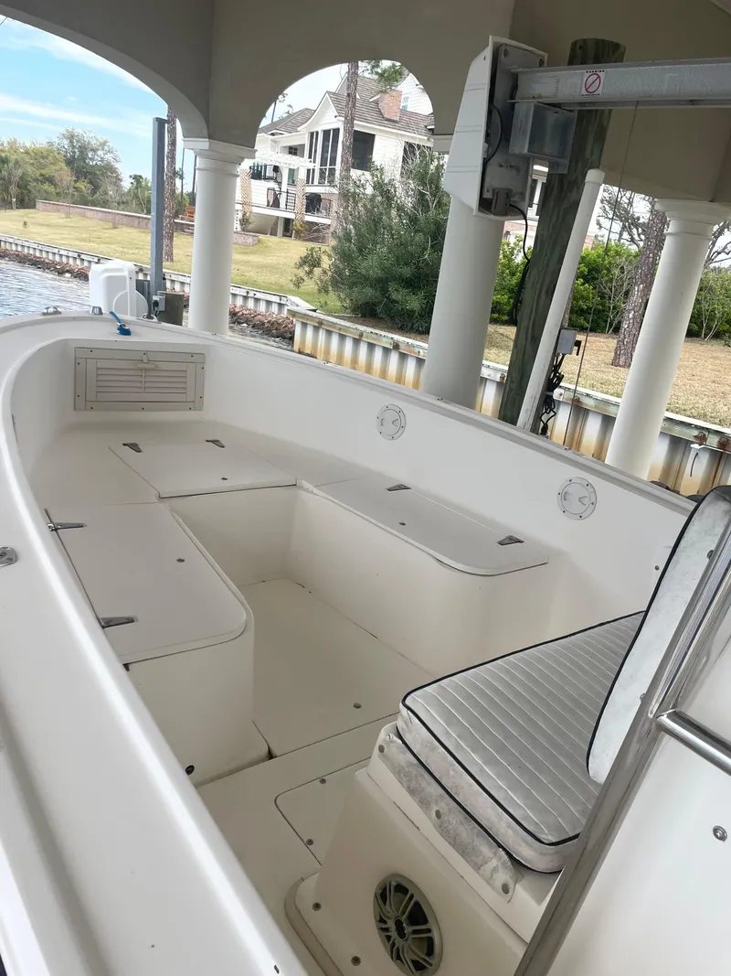 Slide: The Image of 1992 Mako 221 CC boat interior under a covered dock. - 7