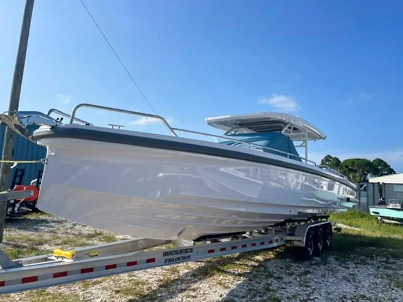 Slide: The Image of 2024 Axopar 37 Sun Top boat on trailer under clear blue sky. - 2