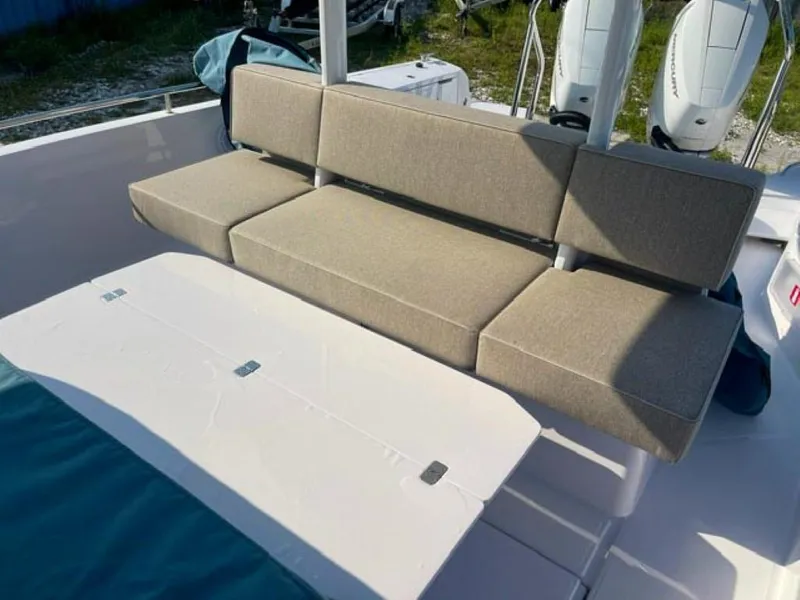 Slide: The Image of 2024 Axopar 37 Sun Top boat seating area with beige cushions. - 5