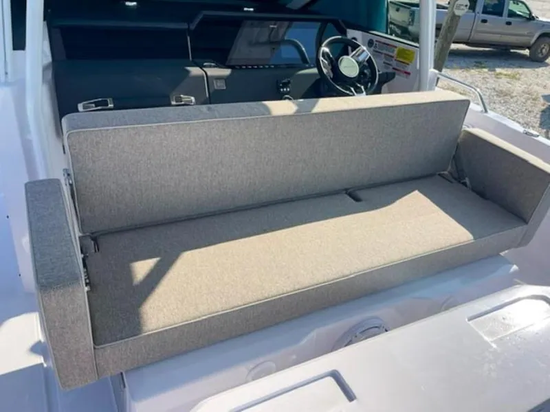 Slide: The Image of 2024 Axopar 37 Sun Top boat interior with cushioned seating and steering console. - 6
