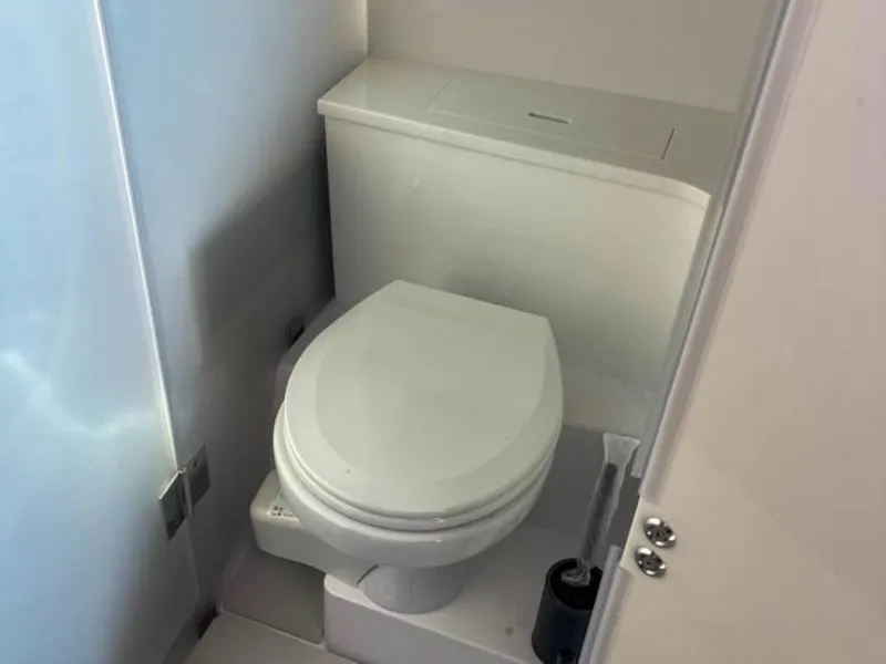 Slide: The Image of 2024 Axopar 37 Sun Top boat bathroom with modern toilet design. - 8
