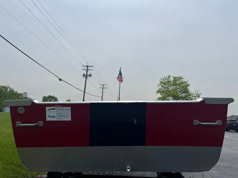 Slide: The Image of 2024 Lund WC-14 boat, rear view, red and silver, outdoors. - 12