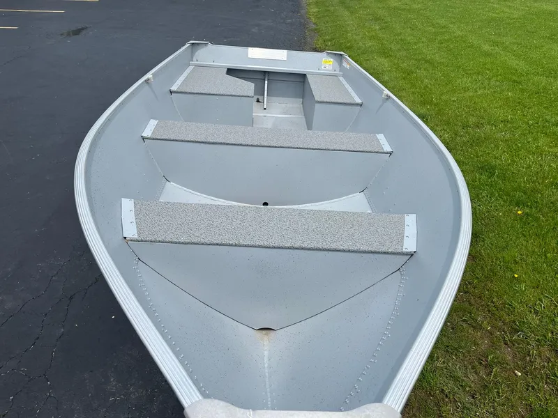 Slide: The Image of 2024 Lund WC-14 aluminum fishing boat on pavement near grass. - 4