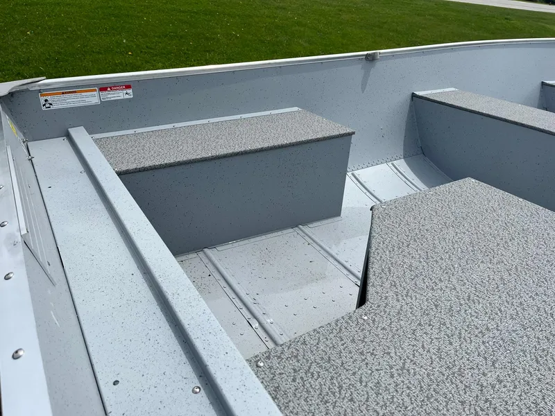 Slide: The Image of 2024 Lund WC-14 boat interior with bench seats and aluminum flooring. - 7
