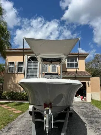 Slide: The Image of 2021 Wellcraft 222 Fisherman boat on trailer in front of house. - 5