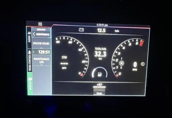 Slide: The Image of Dashboard display of a 2021 Wellcraft 222 Fisherman showing engine hours and fuel levels. - 6
